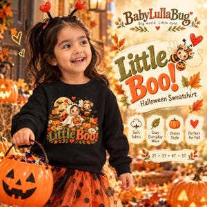 May include: A black long-sleeve sweatshirt featuring a graphic of a child in a ghost costume holding a pumpkin, surrounded by bees, flowers, and autumn leaves. The text reads BabyLullaBug, Little Boo!, and Halloween Sweatshirt.