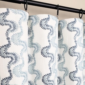 May include: White curtains with a blue and gray swirling pattern. The curtains are hung on a black curtain rod.
