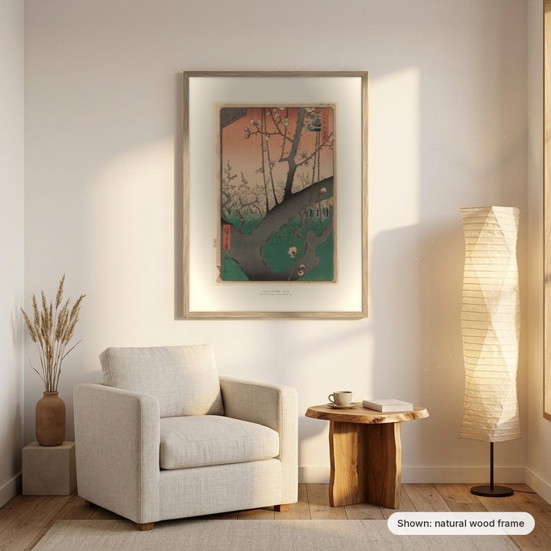 Hiroshige's Plum Park in Kameido in a natural wood frame on a living room wall above an armchair