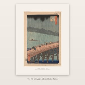The full print of Hiroshige's Sudden Shower with its washi-tone margin and caption, as it sits inside the frame