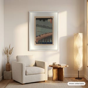 Hiroshige's Sudden Shower in a white frame on a living room wall