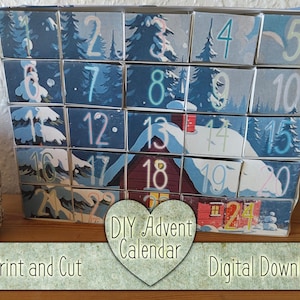 Pode incluir: Um calendário do Advento DIY azul e branco com 24 compartimentos numerados, cada um com uma cena de inverno. O calendário apresenta imagens de casas e árvores cobertas de neve. O texto "DIY Advent Calendar" é visível.