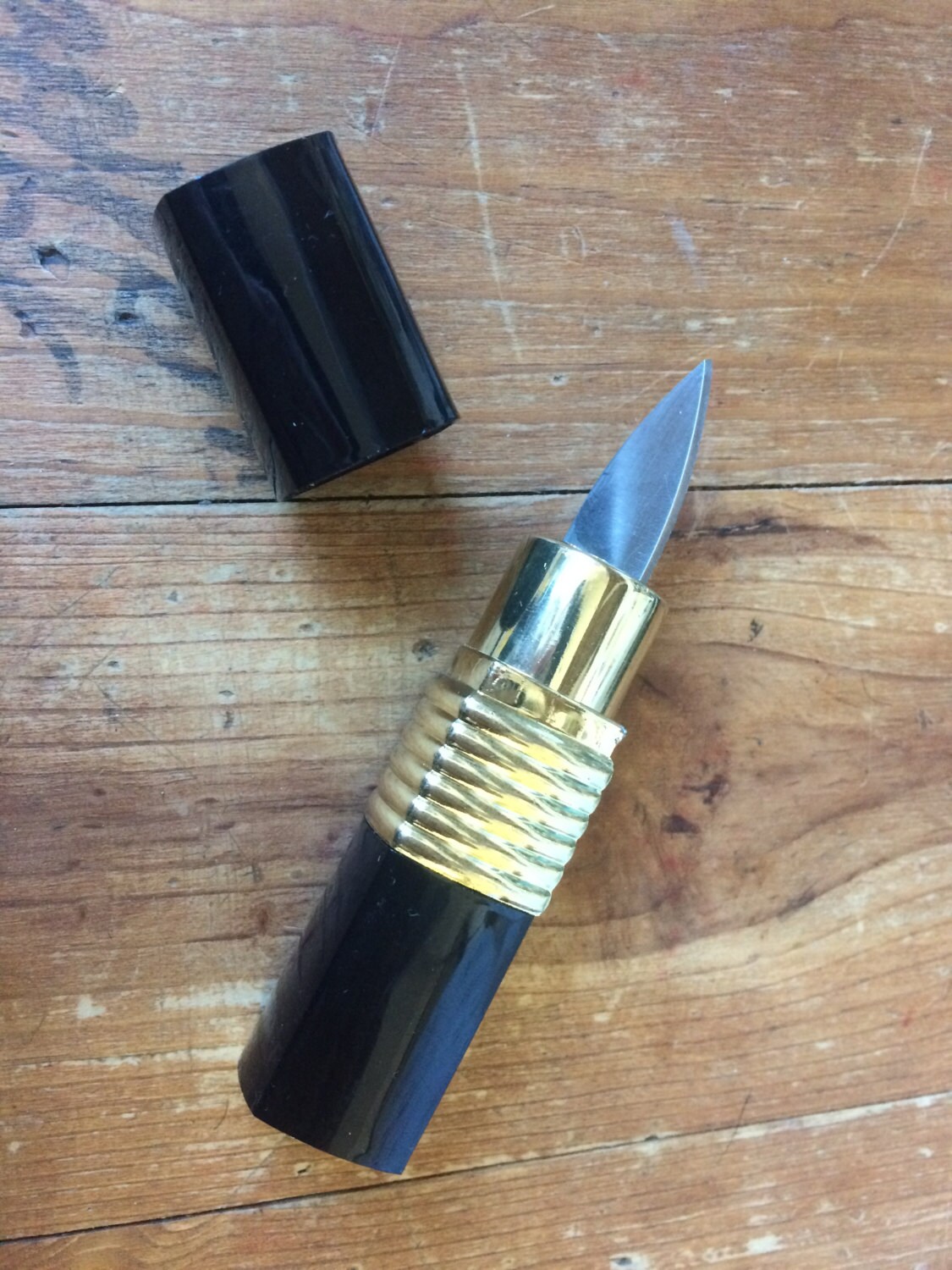 Hidden Lipstick Knife available only in red. Etsy