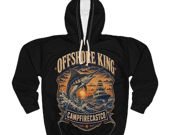 May include: A black hooded sweatshirt featuring a graphic print of a marlin jumping out of ocean waves near a fishing boat at sunset. The text OFFSHORE KING is arched above the illustration, and CAMPFIRECASTCO is printed on a banner below.