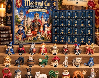 May include: A Medieval Cat advent calendar box featuring a fantasy illustration of cats in royal attire, alongside a blue drawer unit numbered 1 to 24. Twenty-four small cat figurines in various costumes are displayed on wooden steps below.