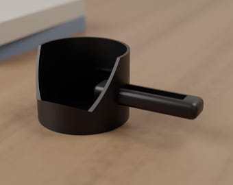 May include: A matte black cylindrical scoop with a wide, open-top design and a sturdy, rectangular handle extending from the side. The scoop features a smooth, solid finish and a deep, hollow interior, constructed with a clean, uniform aesthetic.