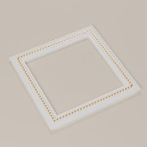 May include: A square white picture frame featuring a border of small, evenly spaced gold-coloured studs or beads embedded along the inner edge of the frame's face. The frame has a clean, flat surface and a simple, geometric square design.