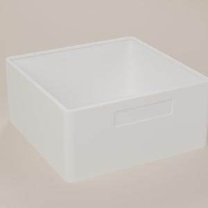 May include: A square, white storage bin with a smooth, matte finish. The container features an open top and a rectangular cutout handle integrated into the front panel, providing a clean, simple design for organising various household items.