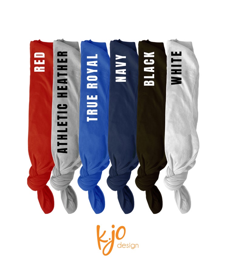 May include: A display of six folded t-shirts in various colors: red, athletic heather, true royal, navy, black, and white. Each shirt has its color name printed vertically in white. The image includes a small, orange logo in the bottom corner.