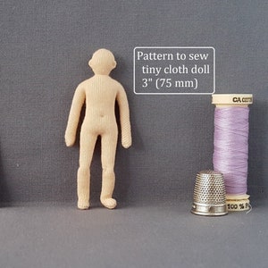 May include: A pattern to sew a 3-inch (75 mm) cloth doll. The pattern is printed on a white card with the text "Prairie Crocus Studio" and contact information.