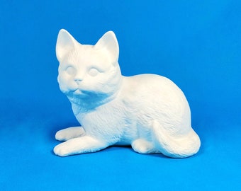 May include: White ceramic cat figurine in a lying down position. The cat has a simple design with no details.