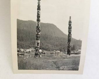 wonderfully old photo of totem poles in a field