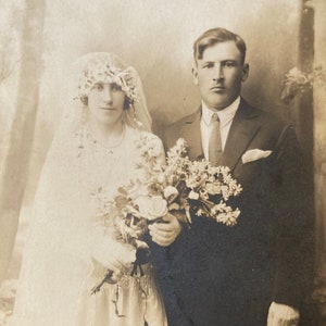 antique sepia photo of bride groom with beautiful bouquet