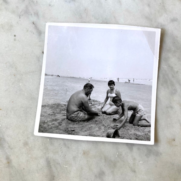 vintage black and white image of family on the beach