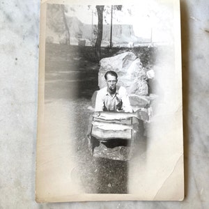 vintage of man sitting with two fish in the middle of a halo