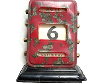 vintage office desktop calendar with red celluloid cover and metal dials