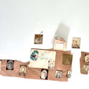 May include: A collection of antique photographs and ephemera, including portraits and a card with floral and bird illustrations. The items are arranged on a torn, textured paper background, with a neutral color palette.