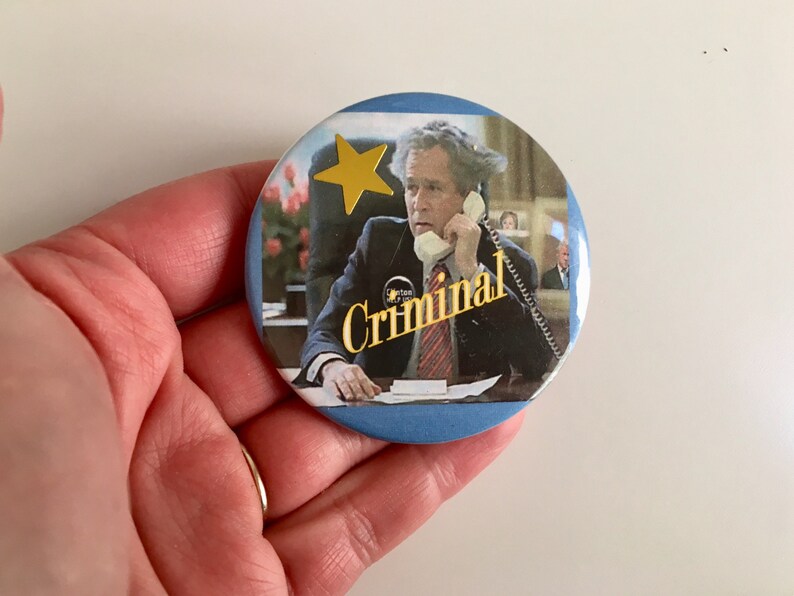 vintage political humor pinback button of president bush that says criminal with added gold star sticker
