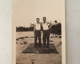 antique black and white photo two men on beach with arm around shoulders