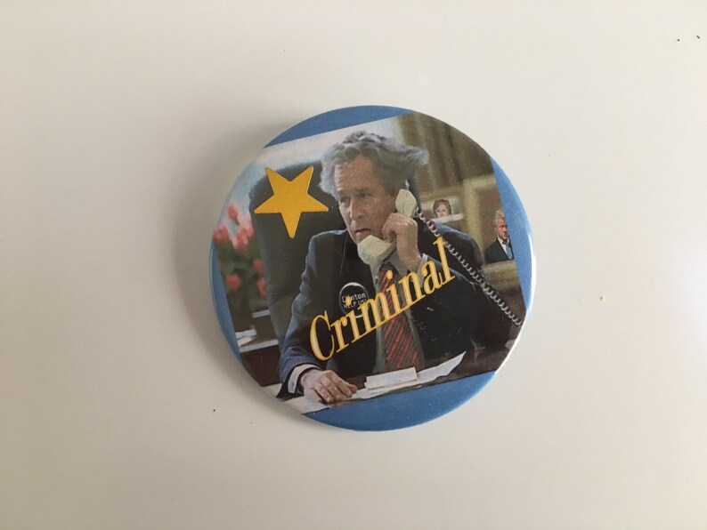 vintage political humor pinback button of president bush that says criminal with added gold star sticker