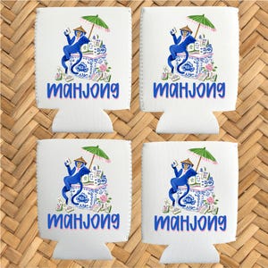 May include: Four white drink koozies with a blue and white illustration of a monkey playing mahjong. The monkey is holding a parasol. The word "mahjong" is written in blue script.