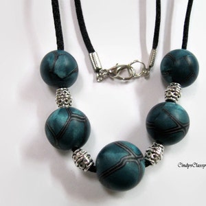 Necklace of Teal Blue Metallic Polymer Clay with black and silver veining 19 inches long silky cord silvertone findings lobster claw clasp