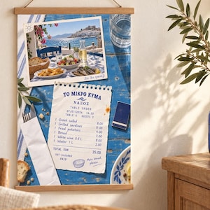 May include: A vertical wall hanging poster featuring a blue wooden table background with a photograph of a seaside meal, a paper restaurant receipt titled TO MIKRO KYMA NAXOS, a wrapped fork and knife, and a small blue matchbox on the surface.