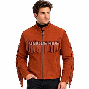 May include: A rust-colored suede jacket featuring a stand-up collar, a full-length front zipper, and long fringe detailing along the chest and sleeves. The text UNIQUE HIDE is printed across the chest area of the jacket.