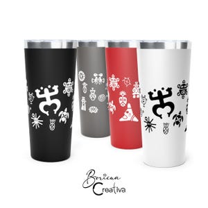 May include: Four cylindrical tumblers in black, grey, red, and white, each featuring metallic rims and white or black Taino petroglyph symbols. The text Boricua Creativa is displayed below the tumblers in a black cursive script font.
