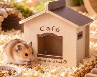 Può includere: Una casetta in legno chiaro per piccoli animali con tetto marrone scuro. La parte anteriore presenta la scritta 'Café' sopra un ingresso aperto e il testo 'Nibbles' Secret Stash' con un'icona di ghianda. Un criceto siede davanti.