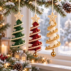 May include: Three hanging crochet Christmas tree ornaments in dark green, deep red, and cream. Each tree is topped with a crocheted star, features a spiraling beaded garland, and hangs from a string with a metallic bell at the base.