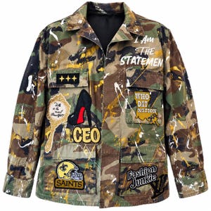 May include: A camouflage print button-down jacket featuring white and yellow paint splatters. Patches include a mirror with text, a high-heeled shoe, the text CEO, a Saints helmet, a map with text, and the text Fashion Junkie.