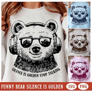 May include: A black and white illustration of a bear wearing headphones and sunglasses. The bear is looking directly at the viewer. The text "Silence is Golden Stop Talking" is written below the bear.