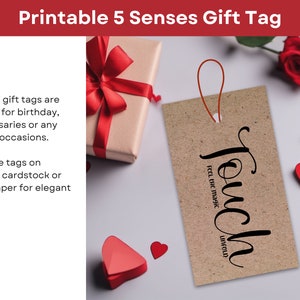 May include: Printable gift tag with the word "Touch" and the text "Feel the magic unfold". The tag is brown and has a red string attached to it. The tag is surrounded by red hearts and a red rose.