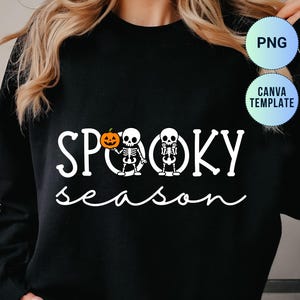 Op de afbeelding: Zwart shirt met lange mouwen met de witte tekst "SPOOKY season". Het woord "SPOOKY" heeft twee skeletfiguren en een pompoen. Een PNG- en Canva-sjabloongrafiek staat in de rechterbovenhoek.