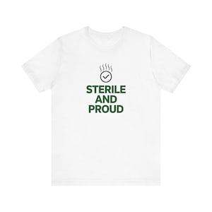 May include: A white short-sleeved t-shirt featuring a dark green graphic on the chest. The graphic consists of a circular icon with a checkmark and steam lines above it, followed by the text STERILE AND PROUD in a bold, sans-serif font.