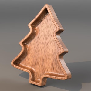 May include: A wooden tray shaped like a Christmas tree with a recessed centre and visible wood grain. The image includes green icons labelled STL and CNC in the corners, indicating a digital file for computer numerical control machining.