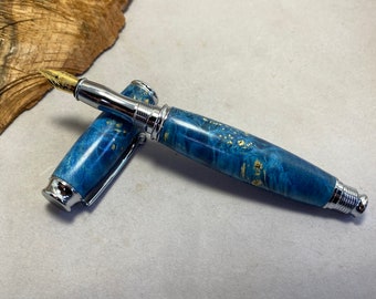 Fountain pen made with blue dyed and stabilized buckeye burl