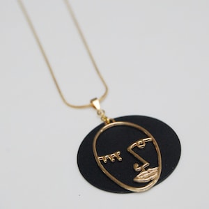 Abstract face pendant in gold or silver