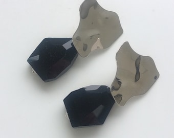 Large asymmetric studs in gold or silver, with big black crystal