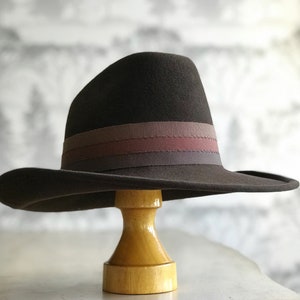 Western style felt brown cowboy hat with tri-colored ribbon trim in brown hues