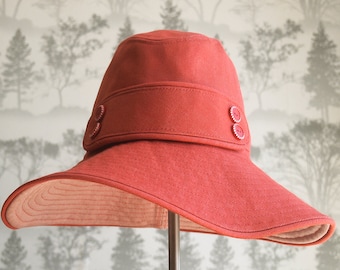 Red denim cotton floppy wide brim hat with decorative band and red and white buttons