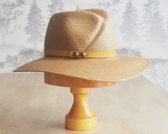 Jules: Gold earth tone straw hat with cross front crown and  sweeping wide brim