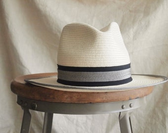 Modest Monroe:  Classic ivory straw fedora hat with black and silver grosgrain ribbon trim with slight up brim