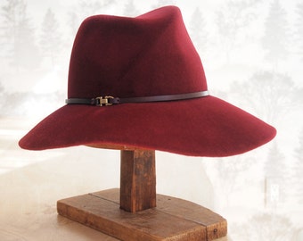 Elle: Cross front tribly crown with floppy soft brim of burgundy velour fur felt with matching leather trim and antique brass finding