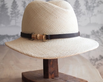 Lucie: Ivory panama straw hat with soft curved center crease.  Trimmed in chocolate hand dyed leather with a bamboo finding.