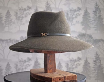 Elle: Cross front tribly crown with floppy soft brim of walnut velour felt with walnut leather trim and antique brass finding.