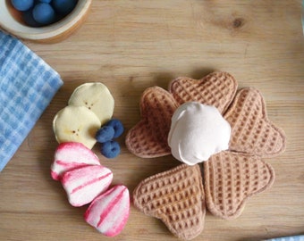 Handmade Danish waffles with fruit and whipped cream for pretend play.