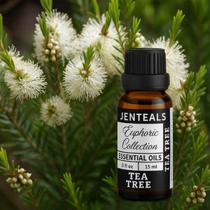 May include: A brown glass bottle of JENTEALS Euphoric Collection Tea Tree essential oil, .5 fl oz (15 ml), with a black cap. The bottle is set against a backdrop of white flowers and green foliage.