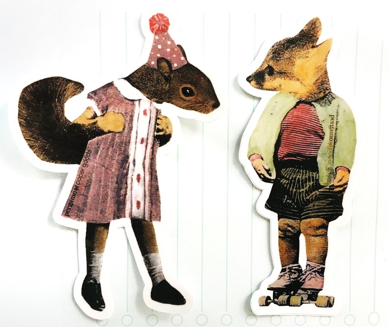 May include: Two whimsical die-cut stickers featuring anthropomorphic animals. One is a squirrel in a pink dress and party hat, the other a fox in a striped shirt and shorts. The squirrel sticker has the text "pergamo paper goods".